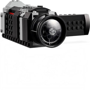 Toy camera made of interlocking bricks on a white background