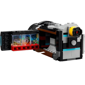[built-detail] Toy camera model made of interlocking bricks with open compartment showing miniature scene inside.