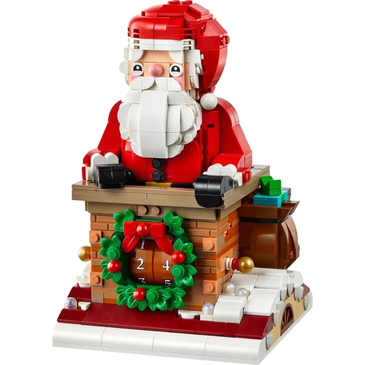 [built-white] A LEGO-style Santa Claus holiday house building set on a plain white background. The model shows Santa seated inside a brick chimney with a green wreath, red bow, brown fireplace, snow, and a red-and-white base.