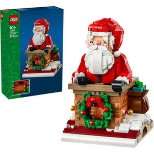[box-set] LEGO Santa in the chimney set shown with its retail box on a white background. The assembled model features a red Santa figure with a white beard emerging from a brown chimney-like structure decorated with a green wreath and red bow, with a small advent calendar and gift bag details.