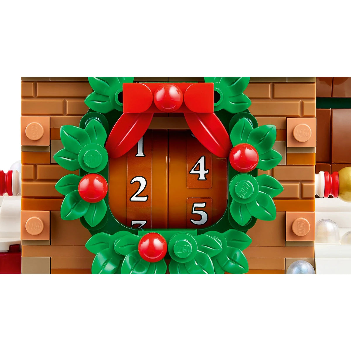 [built-detail] A close-up of a LEGO holiday advent door with a green wreath, red bow, and red berries surrounding numbered doors.