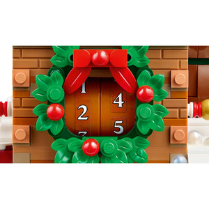 [built-detail] A close-up of a LEGO holiday advent door with a green wreath, red bow, and red berries surrounding numbered doors.