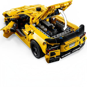 Yellow toy car model with open hood on a white background