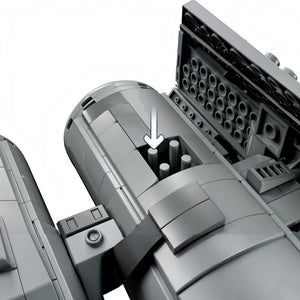 [built-detail] Close-up of a mechanical component with cylindrical parts and an arrow indicating direction.