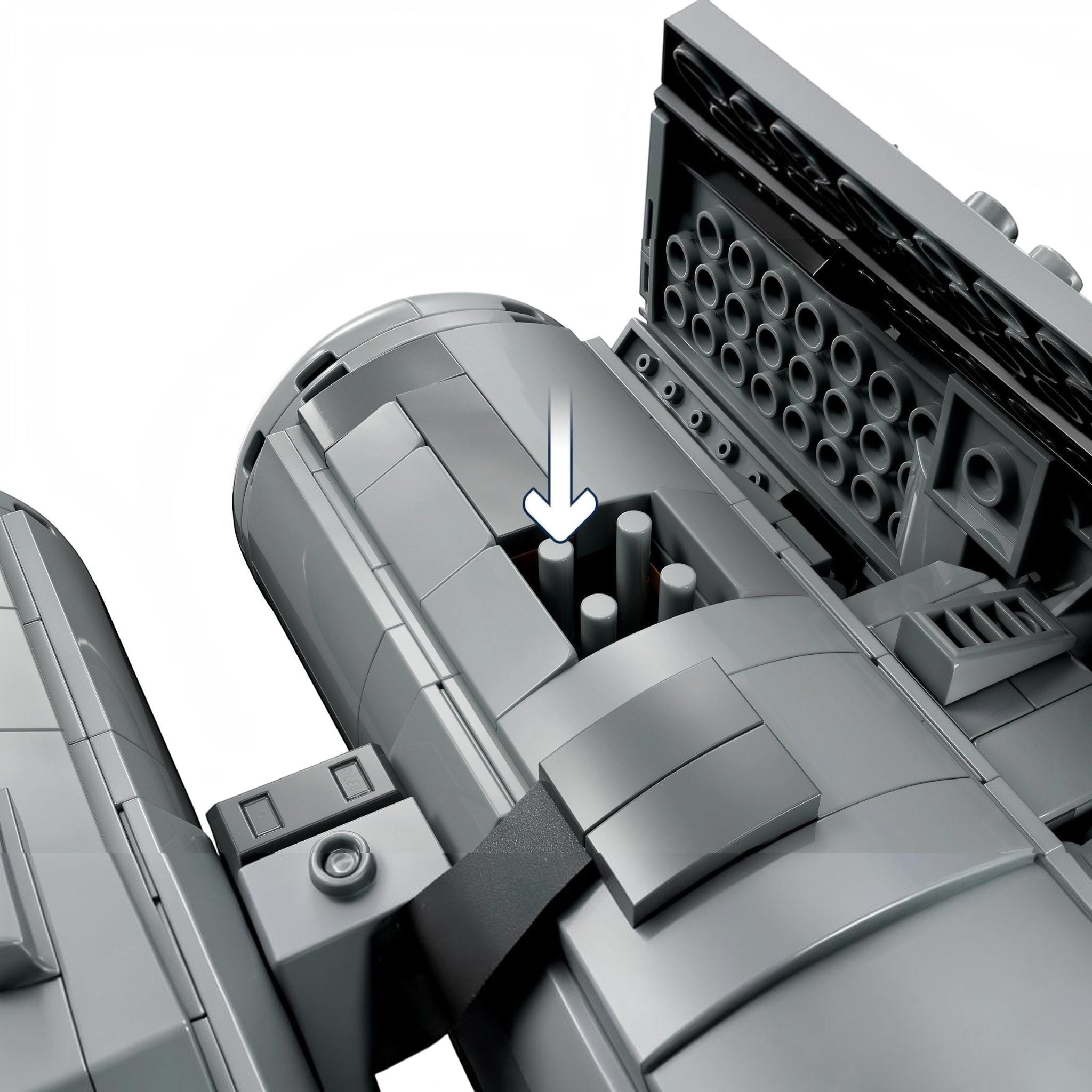 Close-up of a mechanical component with cylindrical parts and an arrow indicating direction.
