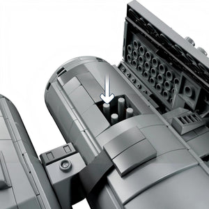 Close-up of a mechanical component with cylindrical parts and an arrow indicating direction.