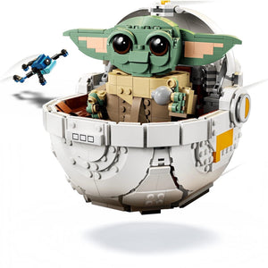 LEGO model of Baby Yoda in a pod with a small drone on a white background