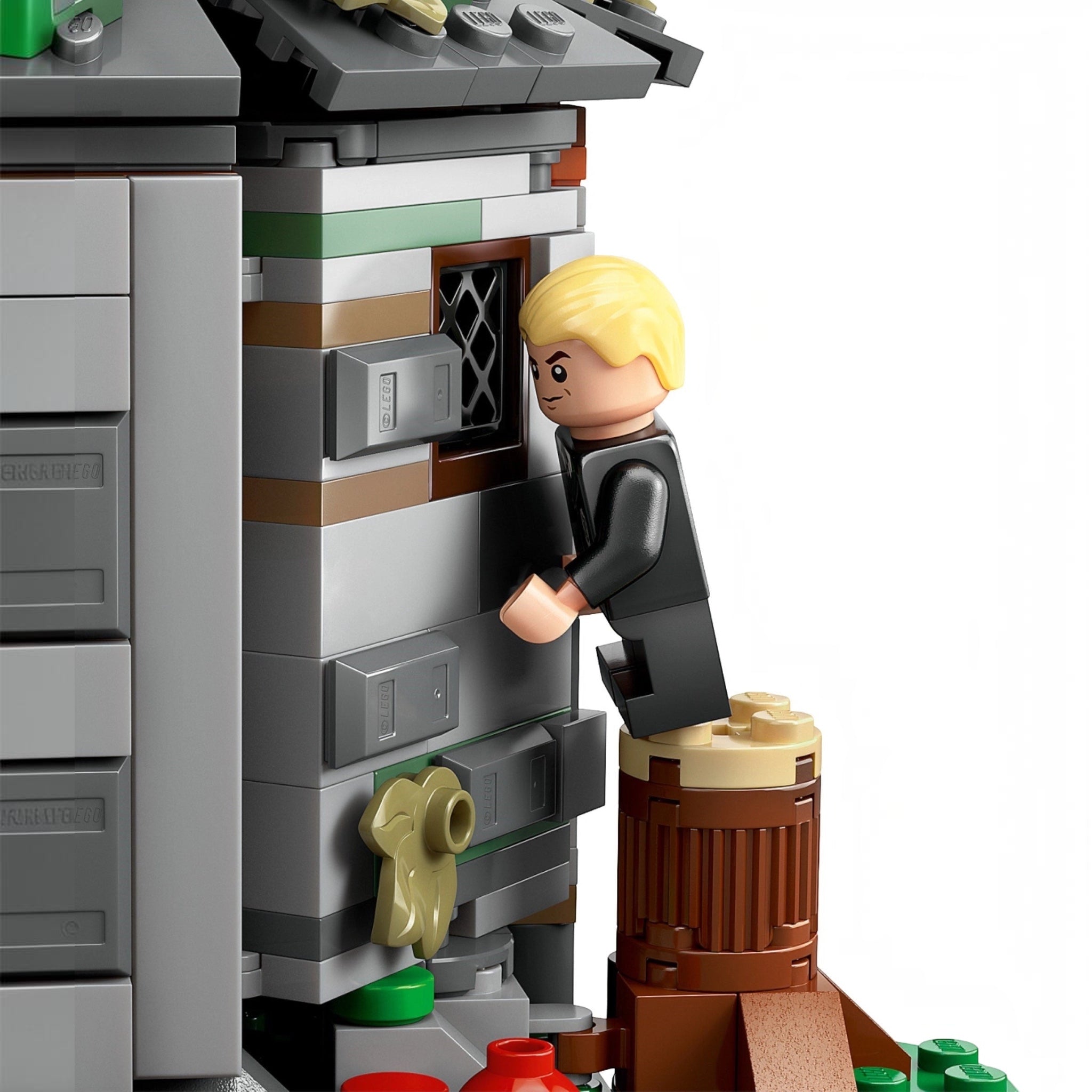 LEGO figure interacting with a detailed building model on a white background