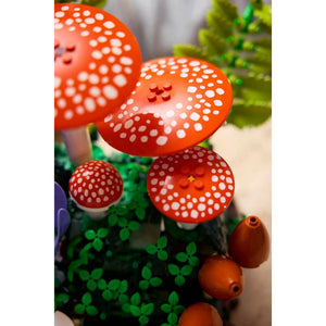 [built-detail] Red and white spotted mushrooms with green leaves on a white background