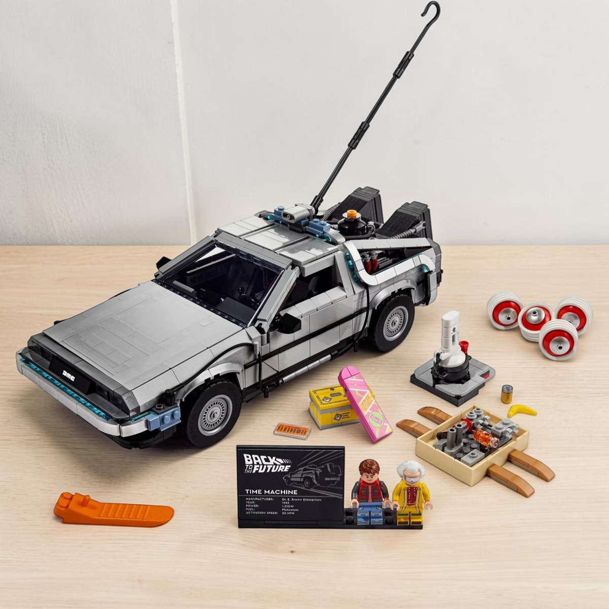 [lifestyle-shelf-built] A Brick Apart LEGO Back to the Future Time Machine model with Doc Brown and Marty McFly minifigures and accessories.
