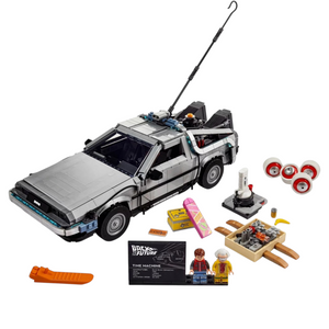 [built-white] A Brick Apart LEGO Back to the Future Time Machine set with car model, Doc Brown and Marty McFly minifigures, and box.