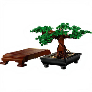 A Brick Apart LEGO Bonsai Tree model with green leaves, brown trunk, black rectangular pot, and wooden display stand.