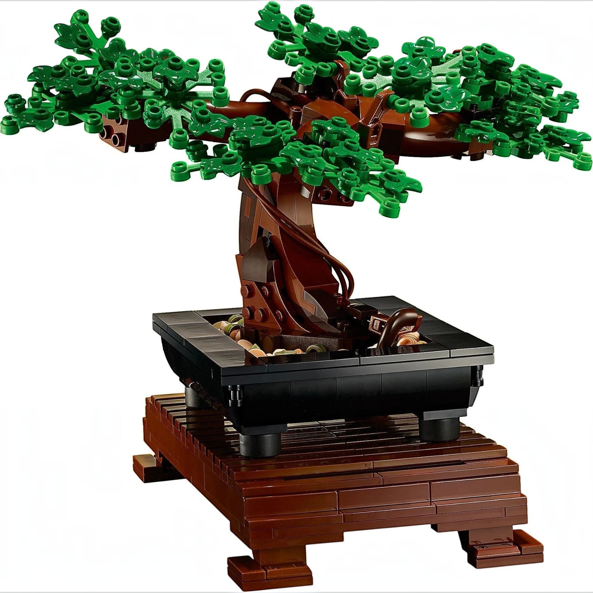 A Brick Apart LEGO Bonsai Tree model with green leaves in a black rectangular pot on a slatted wood-effect stand.