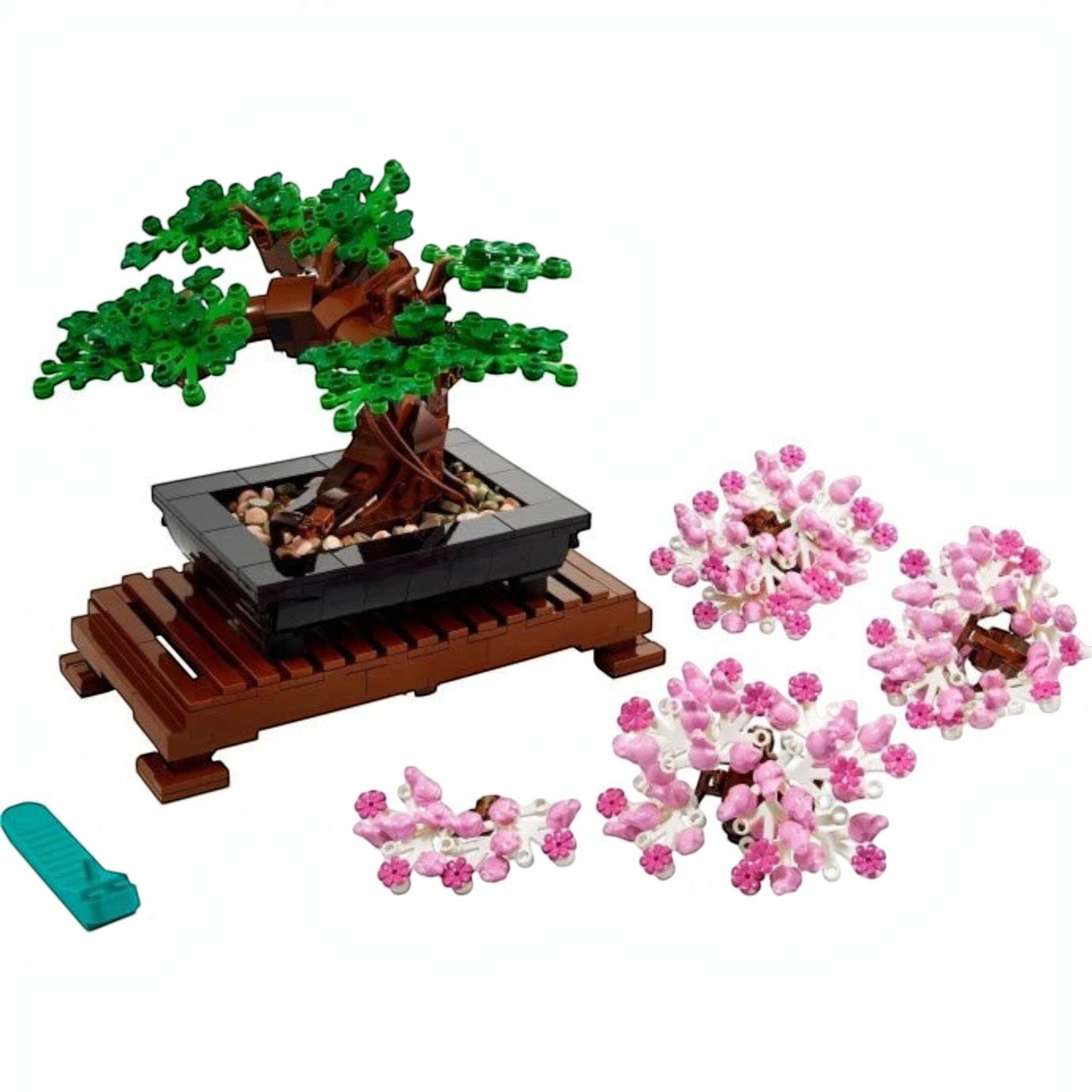 A Brick Apart LEGO Bonsai Tree set with interchangeable green leaves and pink cherry blossom crowns on a wooden stand.