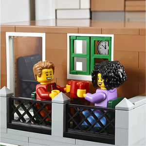 A Brick Apart LEGO Creator Expert Bookshop minifigures sitting on a balcony with a table and chairs