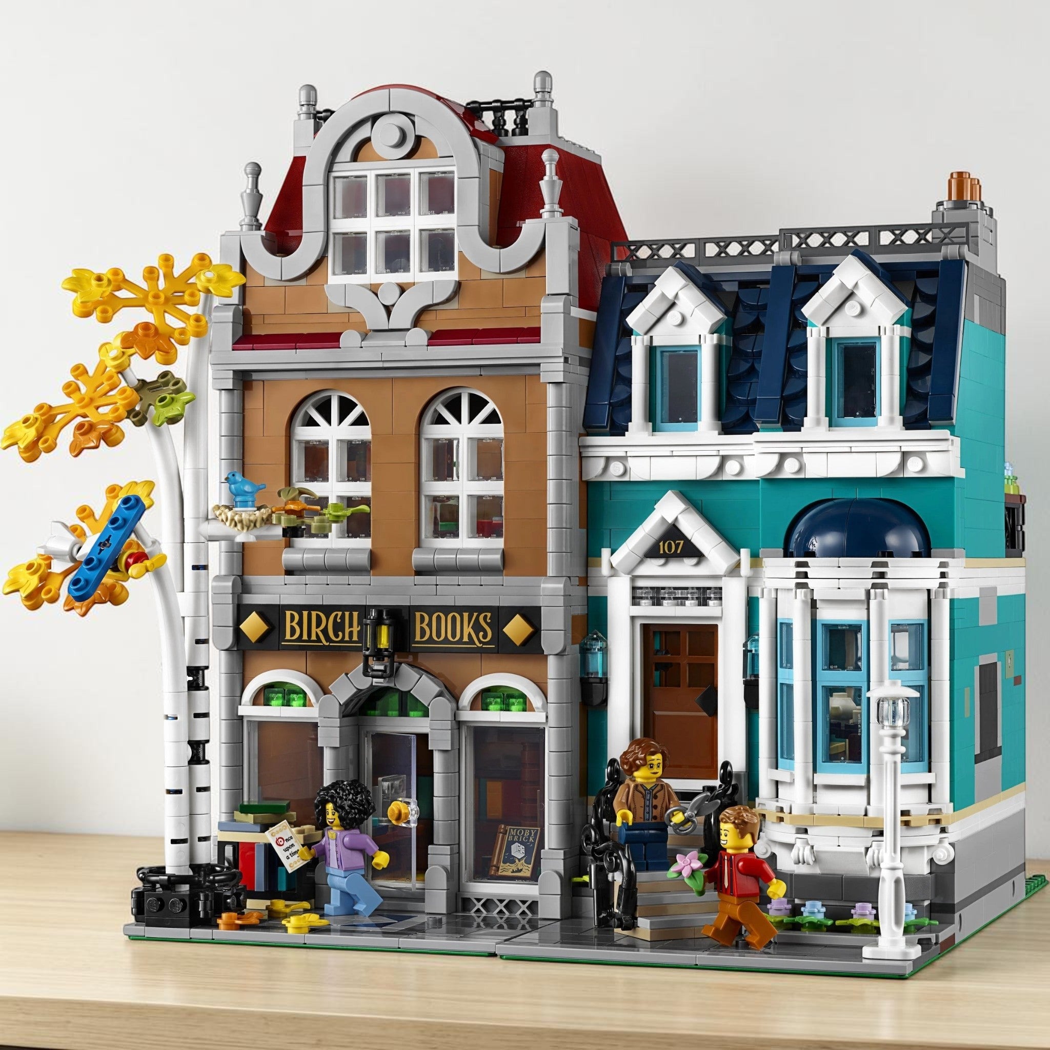 A Brick Apart LEGO Creator Expert Bookshop modular building set with a detailed townhouse, minifigures, and autumn tree.