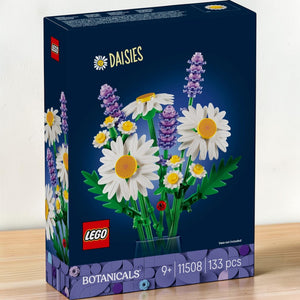 A Brick Apart LEGO Botanicals Daisies building set box featuring a bouquet of white daisies, lavender, and a ladybug.