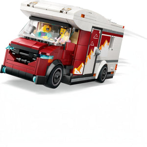 A Brick Apart LEGO City Holiday Camper Van in red and white with minifigures driving on a white background