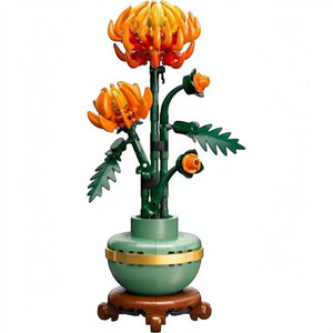 A Brick Apart LEGO Icons Chrysanthemum set featuring vivid orange flowers in a pastel-green pot with a wood-effect base.