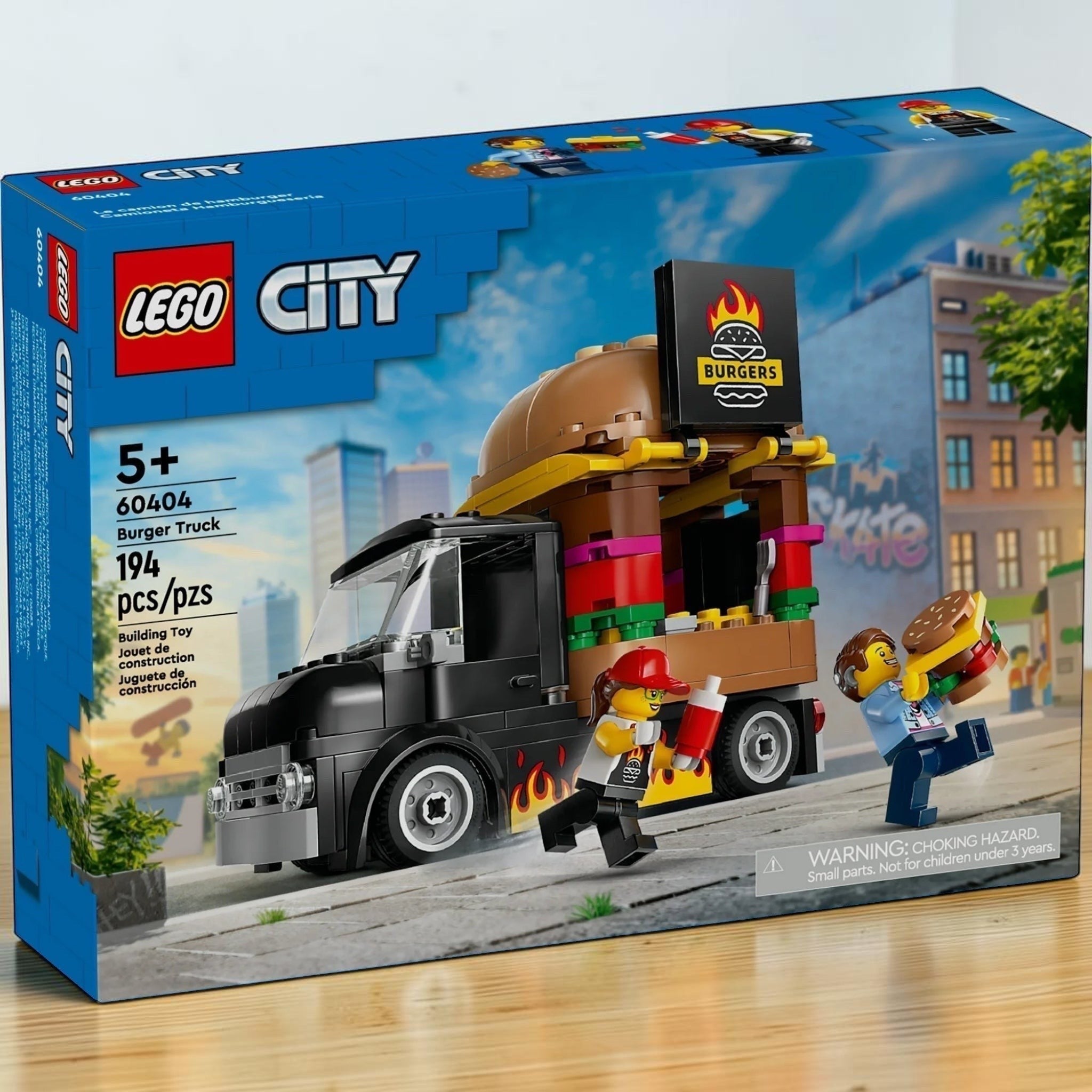 A Brick Apart LEGO City Burger Truck 60404 set box featuring a black food truck with a giant burger sign and minifigures