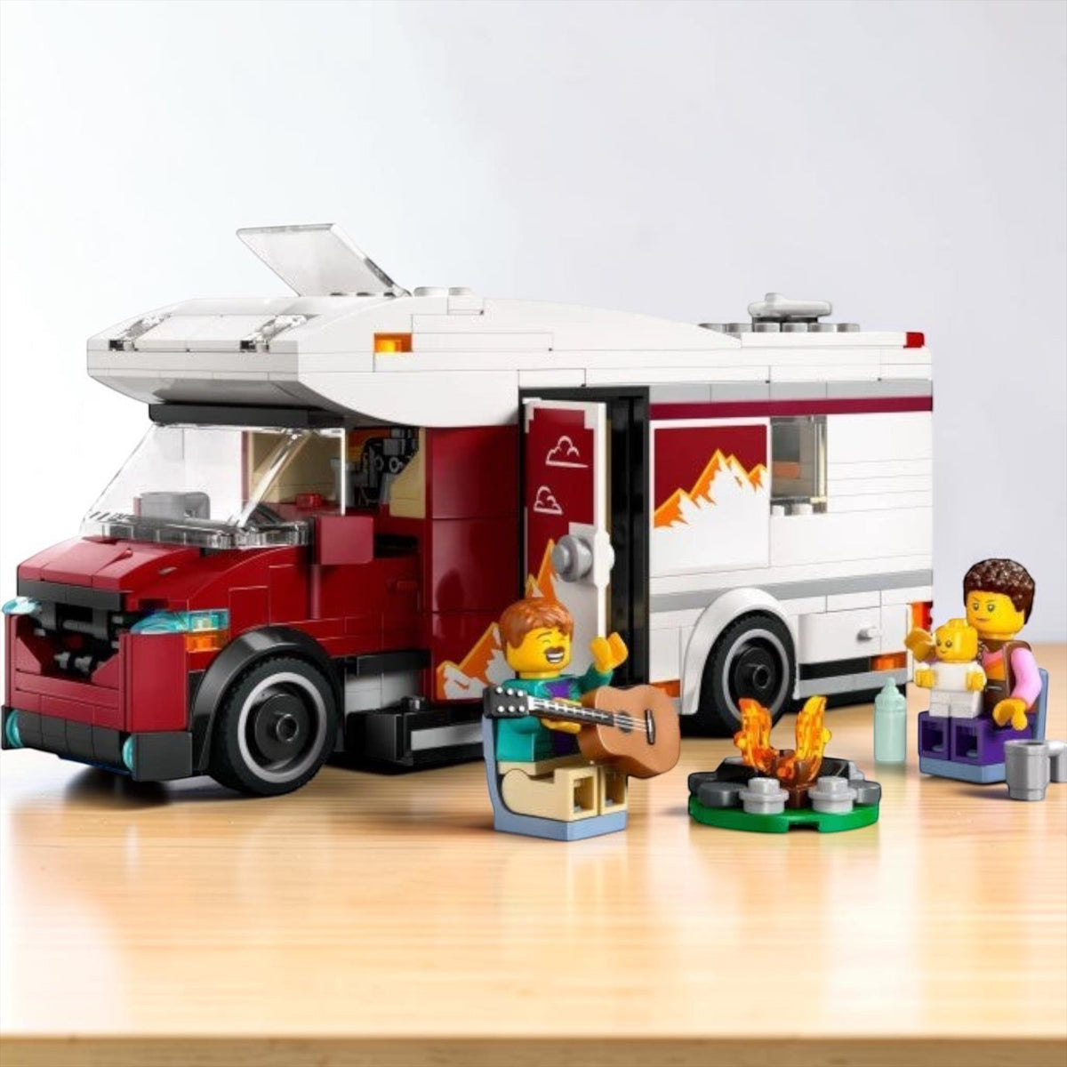 [lifestyle-shelf-built] A Brick Apart LEGO City Holiday Camper Van set featuring a red and white vehicle, minifigure family, and campfire.