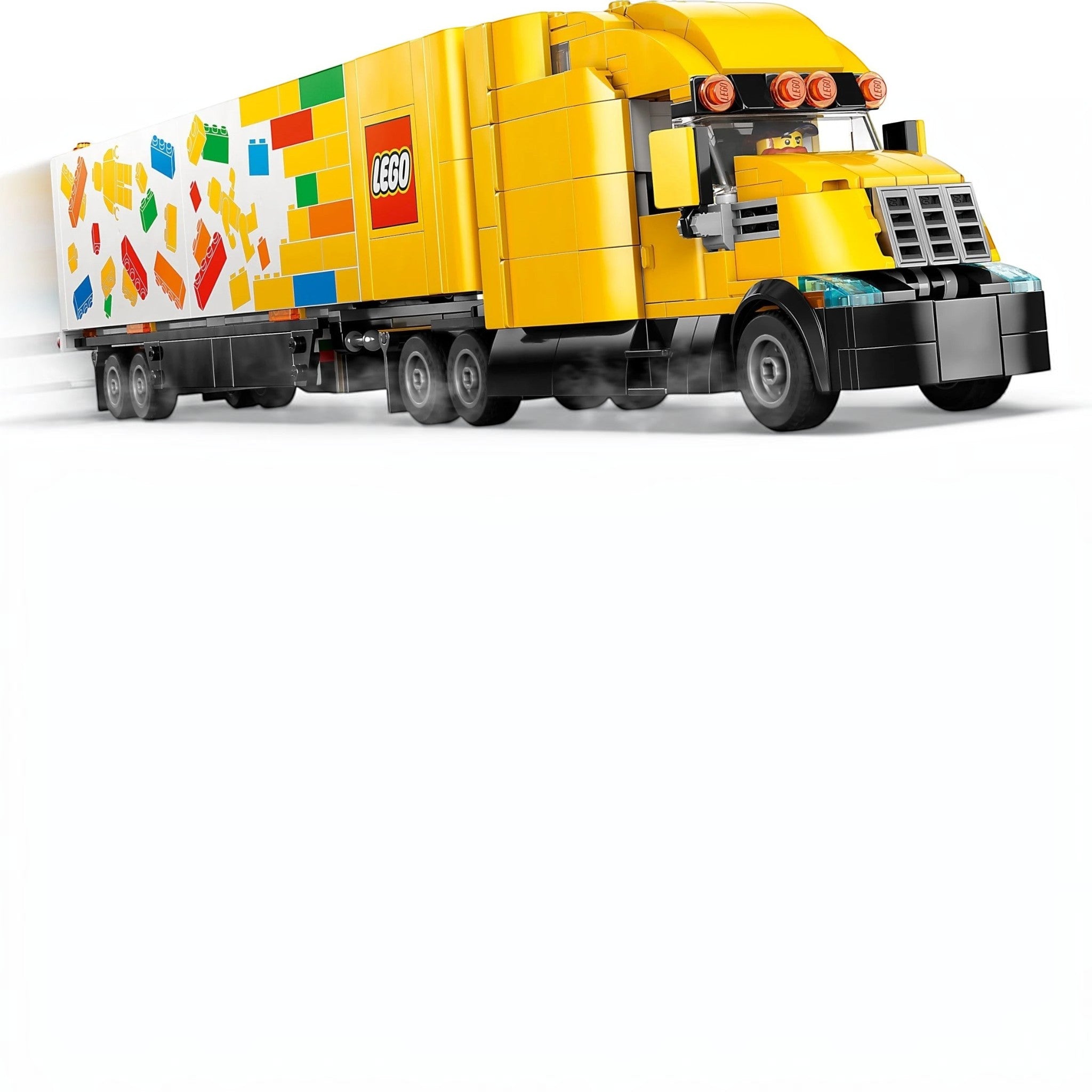 A Brick Apart LEGO City yellow delivery truck with a trailer featuring colorful brick graphics and a minifigure driver.