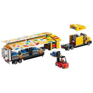 [built-detail] A Brick Apart LEGO City yellow delivery truck set with a trailer, forklift, and minifigures on a white background.