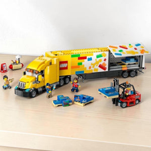 A Brick Apart LEGO City yellow delivery truck with trailer, forklift, hot-dog stand, and four minifigures.