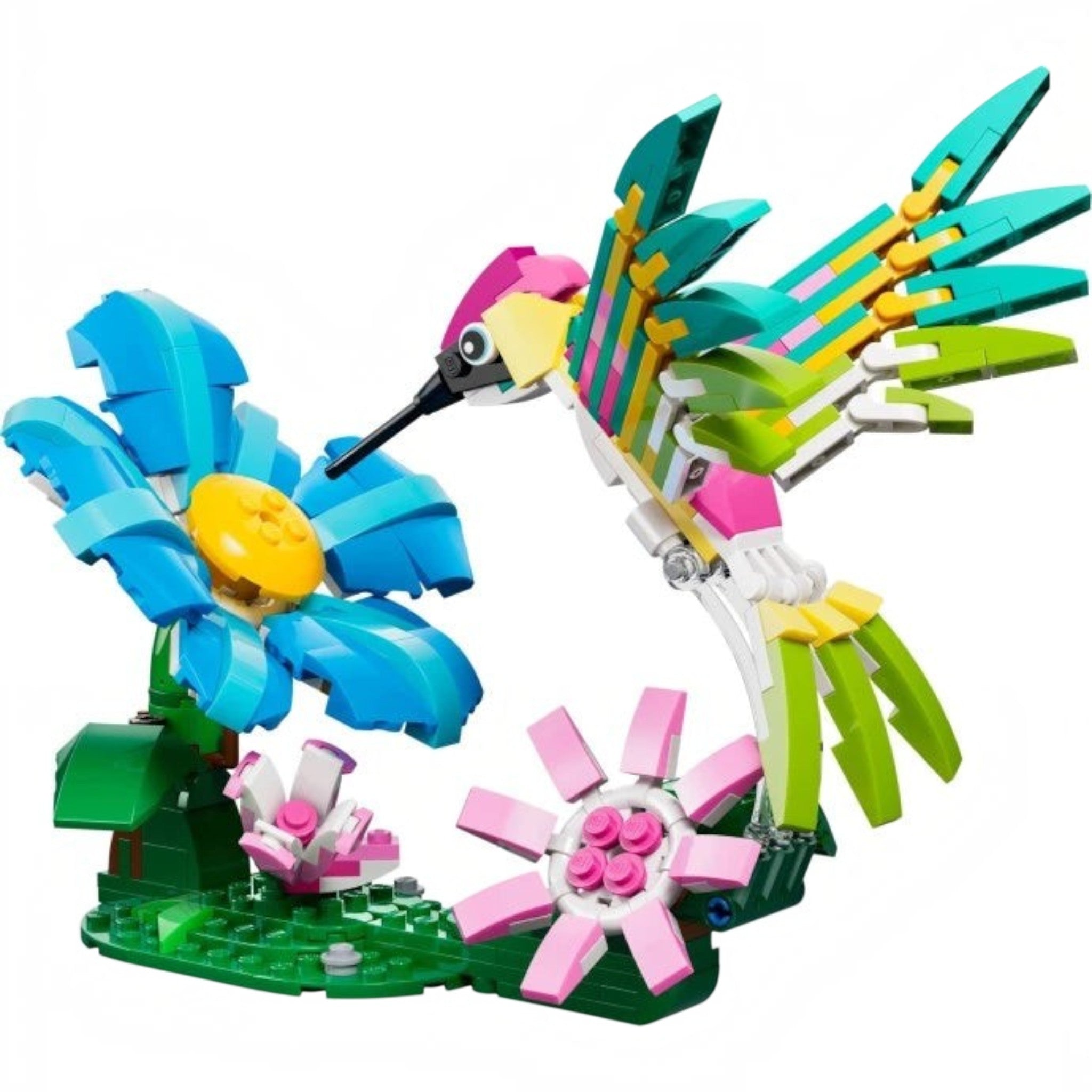 A Brick Apart LEGO Creator colourful hummingbird model hovering over a blue and pink flower build on a green base.