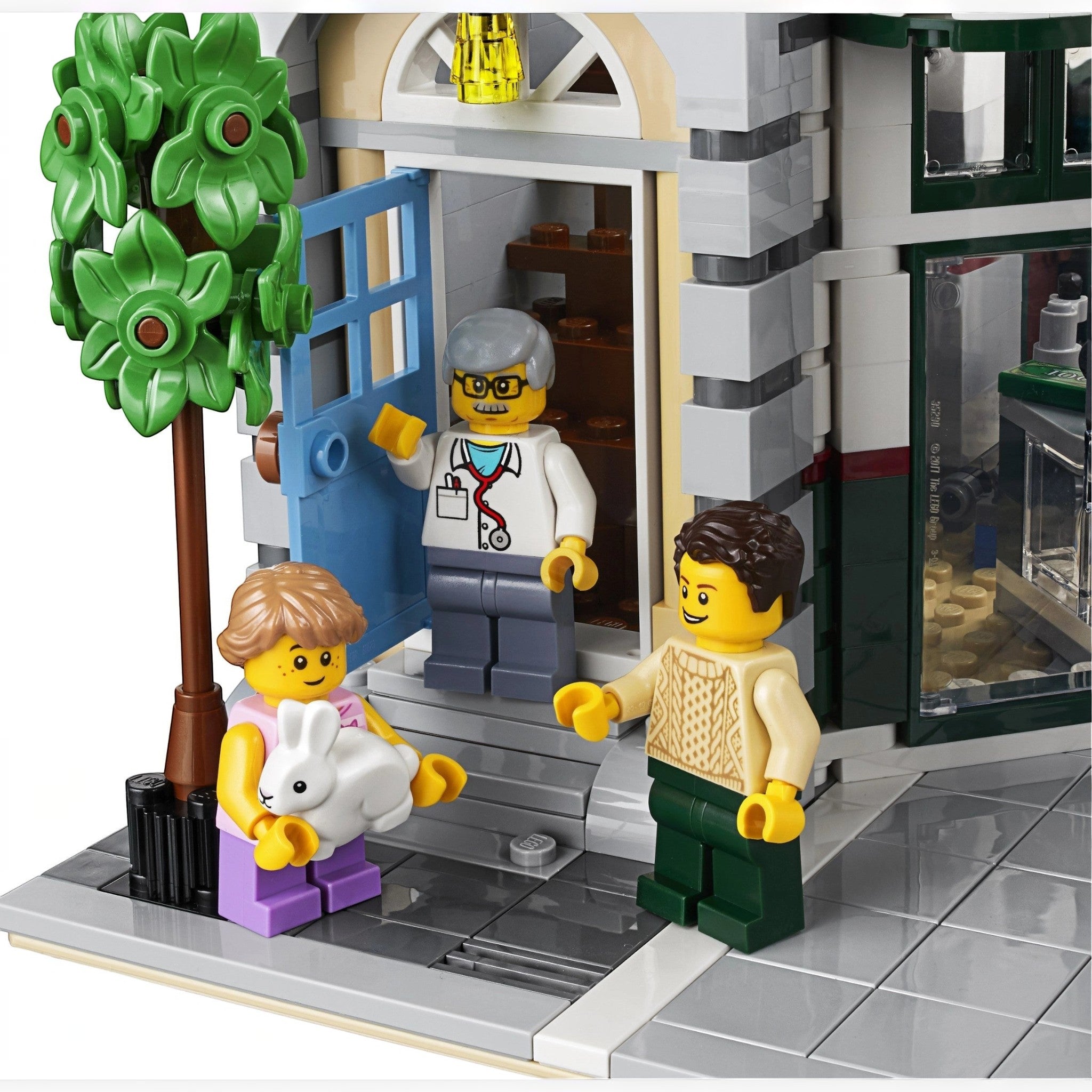 A Brick Apart LEGO Creator Expert Corner Garage set featuring a veterinarian minifigure greeting customers with a rabbit