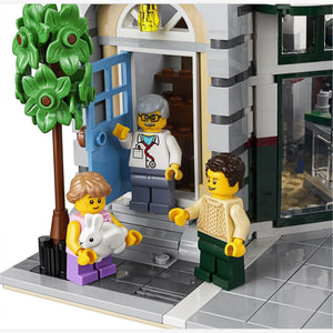 A Brick Apart LEGO Creator Expert Corner Garage set featuring a veterinarian minifigure greeting customers with a rabbit