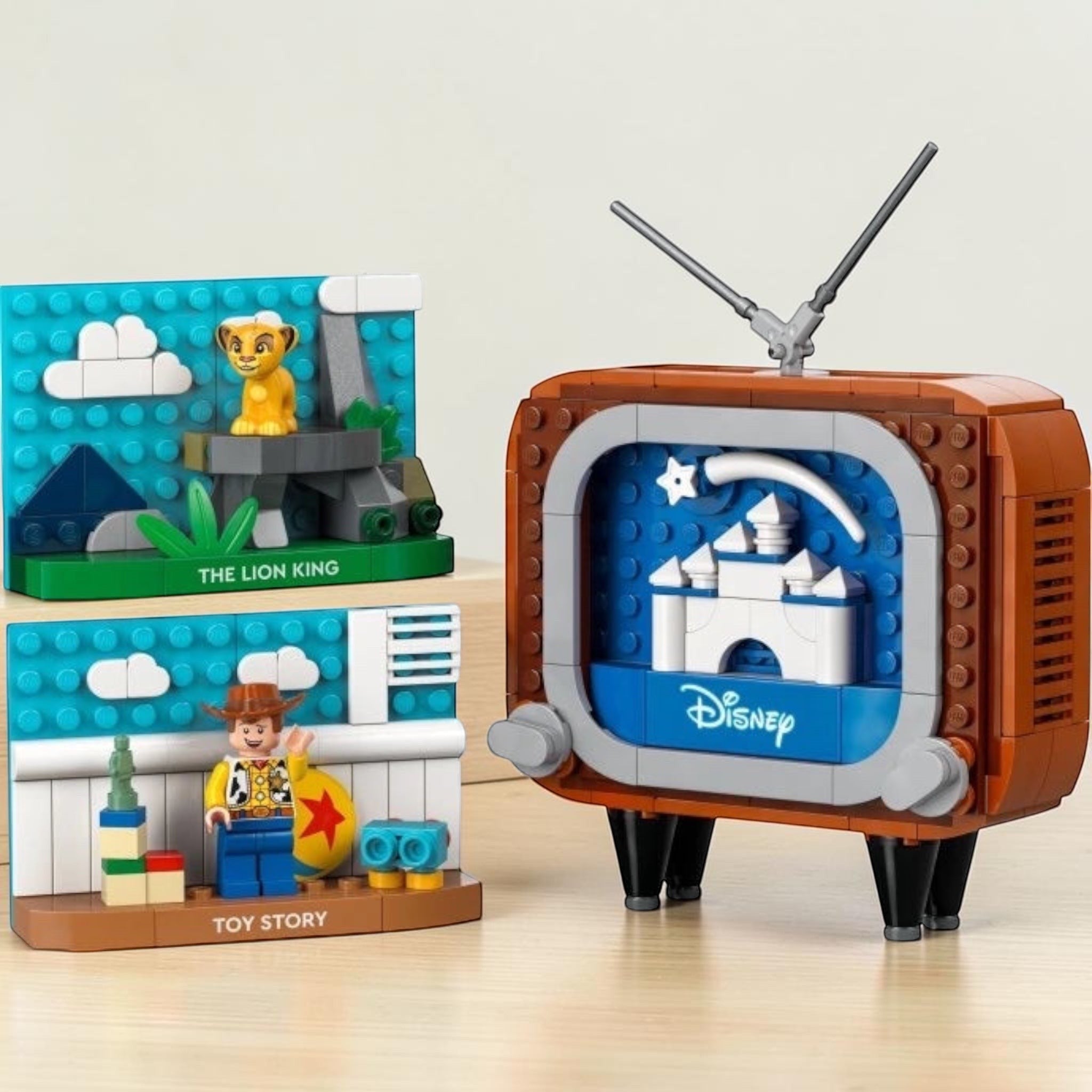 A Brick Apart LEGO Disney Classic Animation Scenes set featuring a retro TV, Simba, and Woody figures.