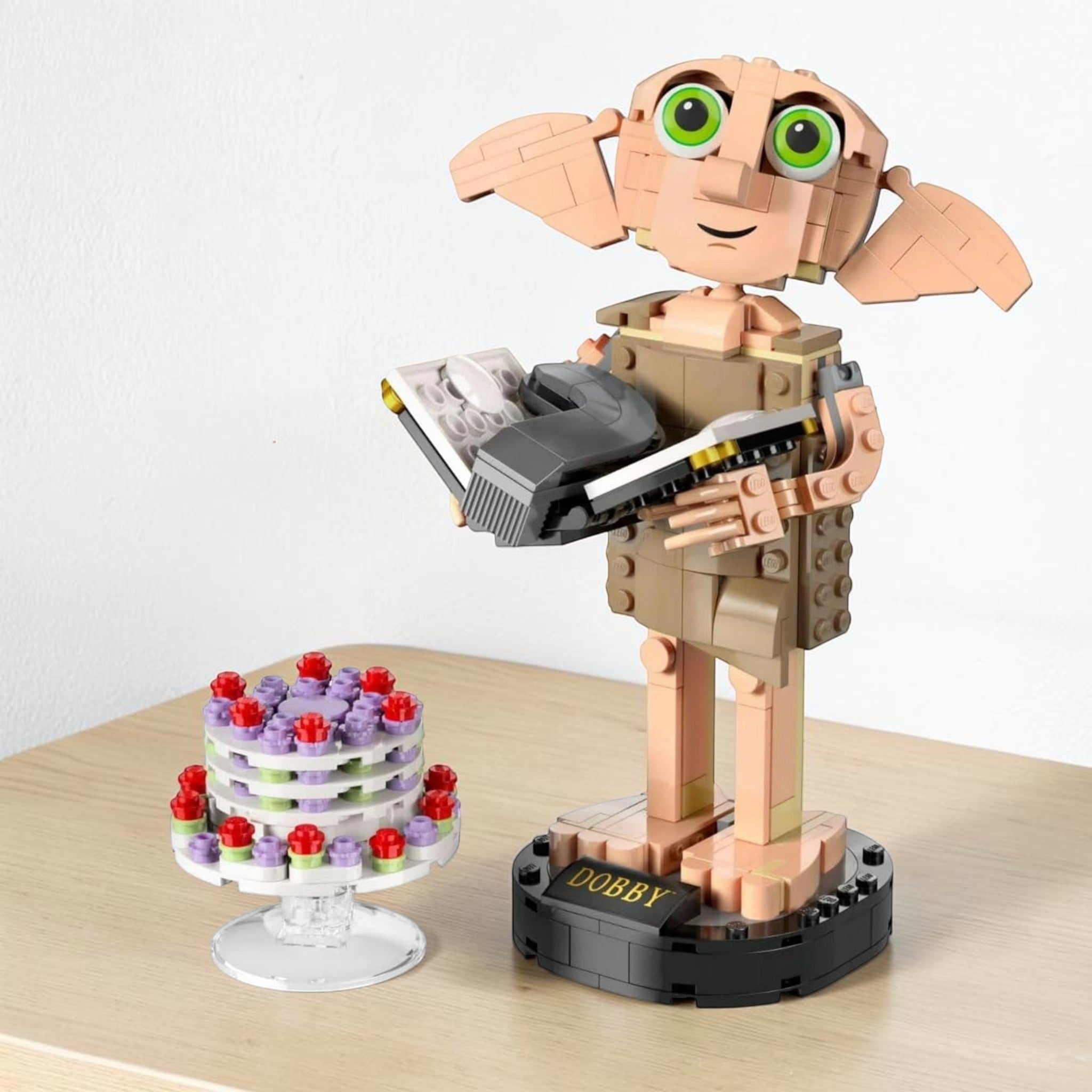 A Brick Apart LEGO Harry Potter Dobby the House-Elf figure with posable limbs, diary, and floating pudding cake.