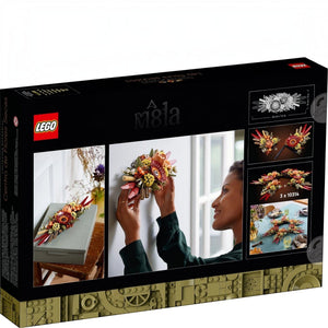 A Brick Apart LEGO Icons Dried Flower Centrepiece box showing a woman mounting the floral arrangement on a wall.