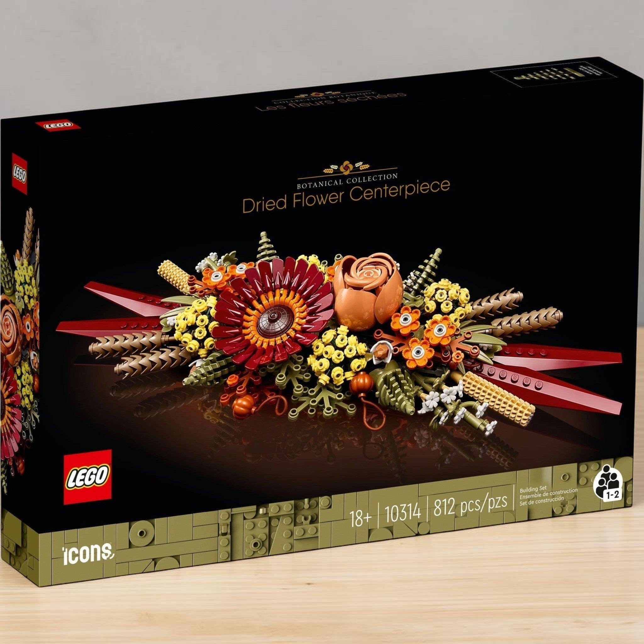 A Brick Apart LEGO Icons Dried Flower Centrepiece box featuring a fall-inspired floral arrangement with gerbera and rose.