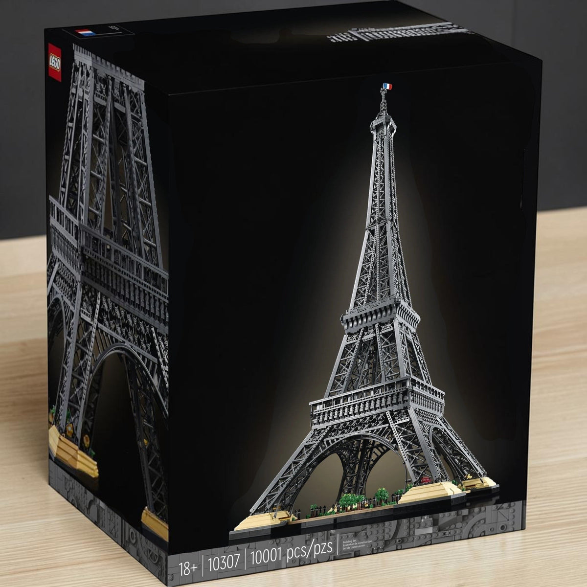 [lifestyle-shelf-box] A Brick Apart LEGO Icons Eiffel Tower 10307 set box featuring the 10,001-piece grey architectural model on display.