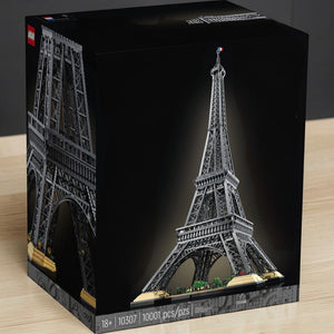 [lifestyle-shelf-box] A Brick Apart LEGO Icons Eiffel Tower 10307 set box featuring the 10,001-piece grey architectural model on display.