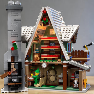 A Brick Apart LEGO Elf Club House set featuring a detailed interior with a waffle machine, fireplace, and elf minifigure