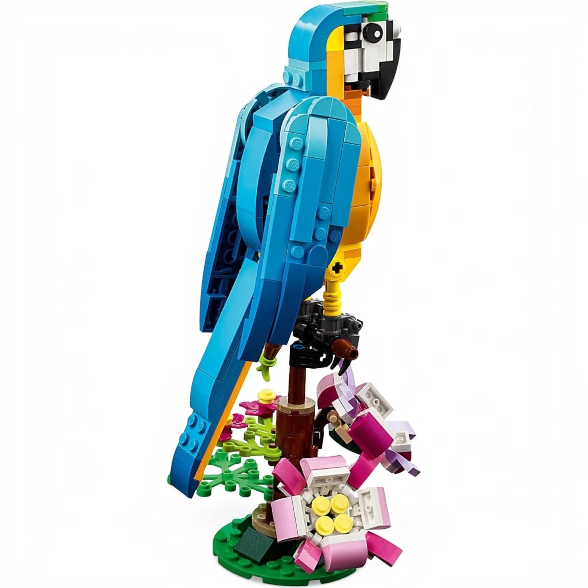 A Brick Apart LEGO Creator 3in1 Exotic Parrot model perched on a flower-covered branch with blue, yellow, and green bricks.