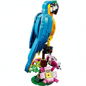 A Brick Apart LEGO Creator 3in1 Exotic Parrot model perched on a flower-covered branch with blue, yellow, and green bricks.