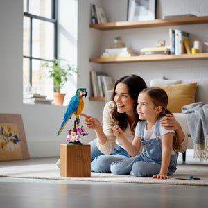 A Brick Apart LEGO Creator Exotic Parrot set featuring a posable blue and yellow bird with a woman and child.