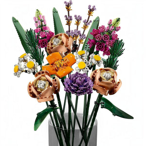 A Brick Apart LEGO Flower Bouquet set featuring colorful plastic roses, daisies, and lavender in a glass vase.