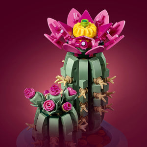A Brick Apart LEGO Botanicals Flowering Cactus set featuring two green cacti with vibrant pink flowers in a blue pot.