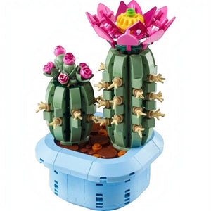 A Brick Apart LEGO Botanicals Flowering Cactus set featuring two green cacti with pink flowers in a pastel blue pot.