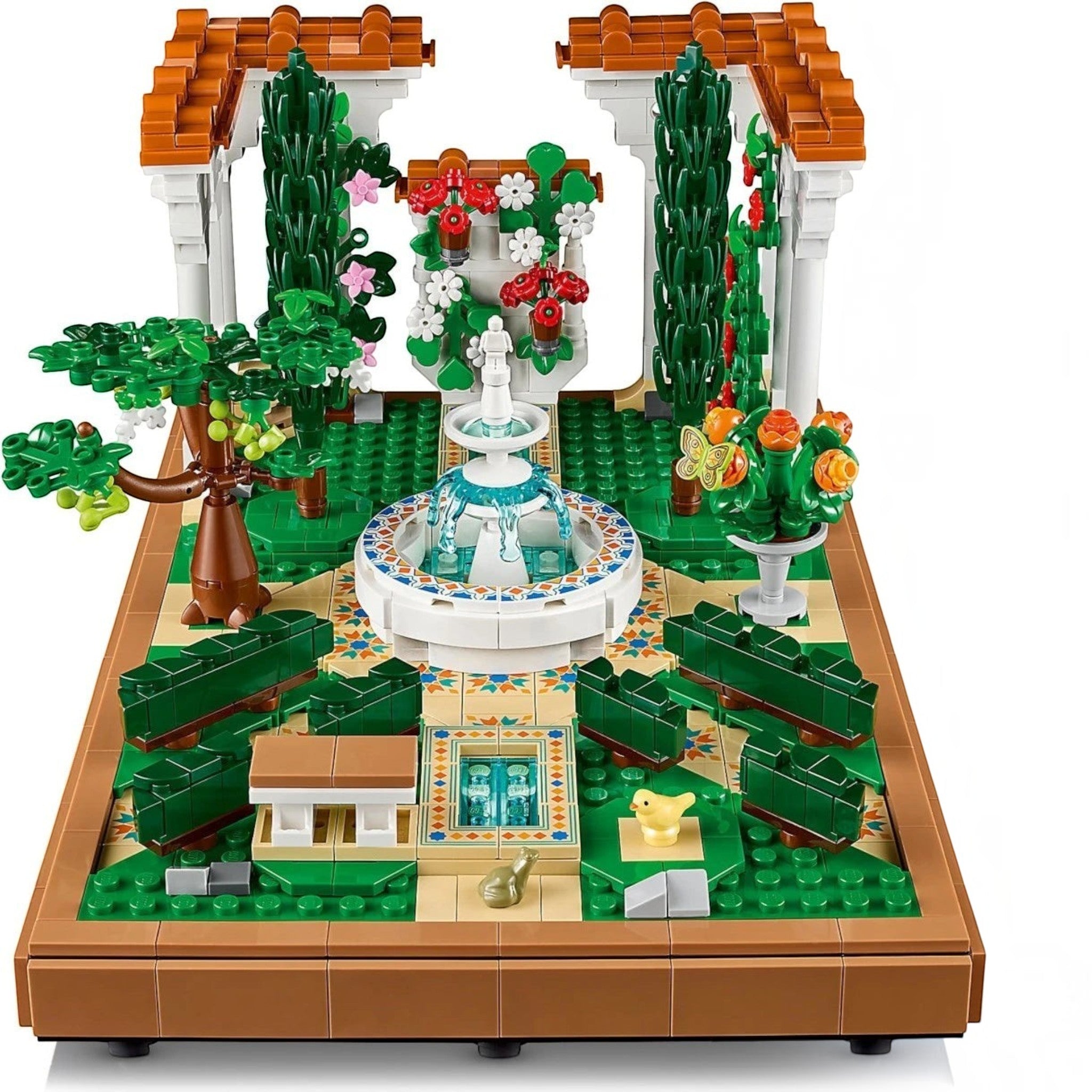 A Brick Apart LEGO Icons Fountain Garden set featuring a tiered fountain, cypress trees, flowers, and tiled pathways.