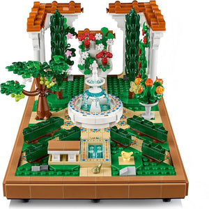 A Brick Apart LEGO Icons Fountain Garden set featuring a tiered fountain, cypress trees, flowers, and tiled pathways.