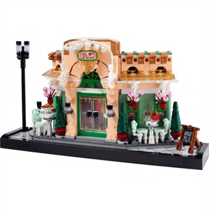 A Brick Apart LEGO Icons French Café set featuring a detailed bistro facade with flowerpots, seating, and streetlamp.