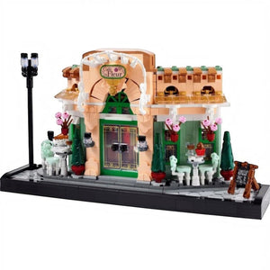 [built-white] A Brick Apart LEGO Icons French Café set featuring a detailed bistro facade with flowerpots, seating, and streetlamp.