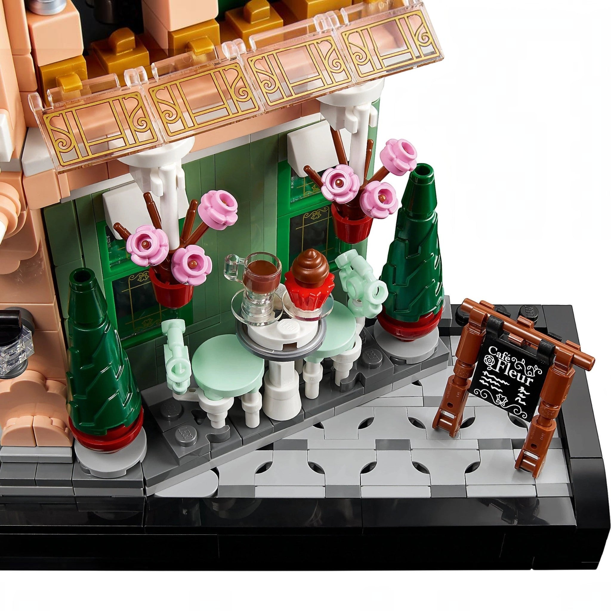 A Brick Apart LEGO Icons French Café set featuring a bistro patio with ornate seating, flowerpots, and a menu board.