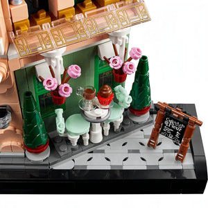 A Brick Apart LEGO Icons French Café set featuring a bistro patio with ornate seating, flowerpots, and a menu board.